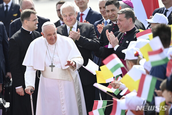 [부다페스트=AP/뉴시스] 프란치스코 교황이 지난 4월28일(현지시간) 헝가리 부다페스트 국제공항에 도착해 세미옌 졸트 헝가리 부총리 등의 박수를 받으며 깃발을 흔드는 어린이들의 환영을 받고 있다. 2023.04.28.