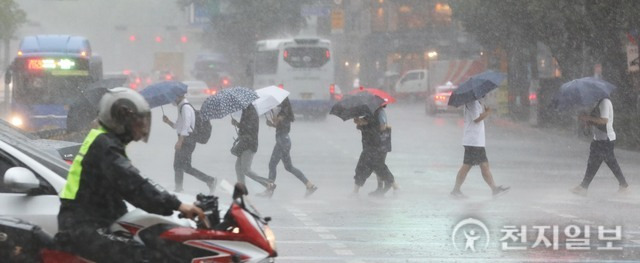 [천지일보=남승우 기자] 장마전선의 영향으로 중부지방에 강하고 많은 비가 내린 8일 오후 서울 종로구 광화문 네거리에서 시민들이 우산을 쓴 채 발걸음을 재촉하고 있다. ⓒ천지일보 2022.08.08