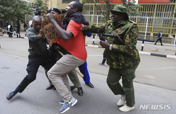 지난 8일(현지시간) 케냐 나이로비 시내에서 높은 생활비와 새로운 세금에 반대하는 시위를 벌이던 한 활동가가 경찰에게 체포되고 있다. (출처: 뉴시스)