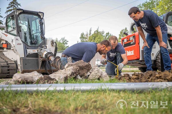 두산밥캣 미국법인 임직원들이 시설 보수 작업을 하는 모습. (제공: 두산밥캣) ⓒ천지일보 2023.09.13.