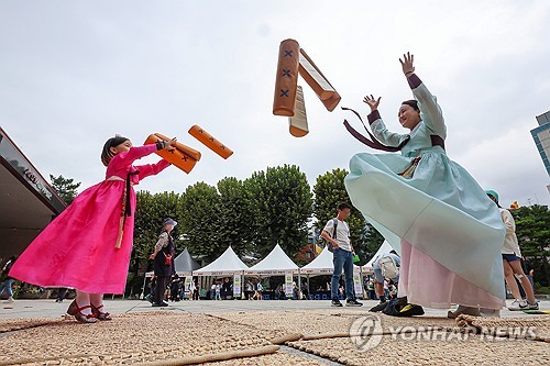 30일 오후 서울 종로구 서울역사박물관에서 열린 한가위 한마당 행사에서 한 어린이가 엄마와 윷놀이를 즐기고 있다. (출처:연합뉴스)