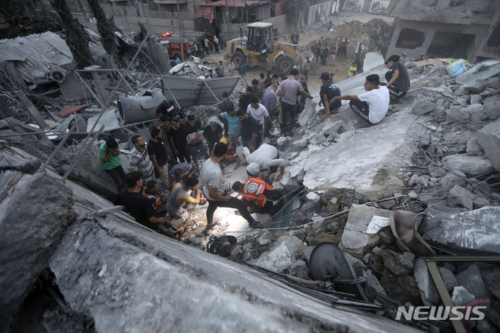 지난달 31일(현지시각) 가자지구 누세이라트 난민촌에서 팔레스타인 주민들이 이스라엘의 폭격으로 무너진 건물 잔해 속 생존자를 찾고 있다. (AP/뉴시스) 2023.11.01.