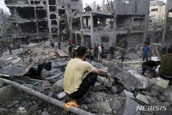 14일(현지시각) 가자지구 자발리야 난민촌에서 팔레스타인 주민들이 이스라엘의 공습으로 파괴된 건물 잔해 속 생존자를 찾고 있다. (출처:AP/뉴시스)