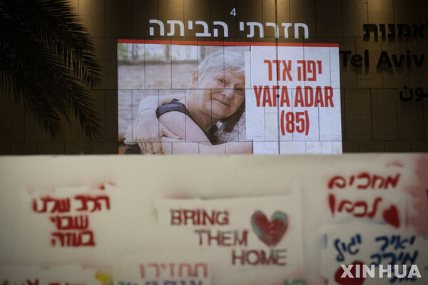 24일(현지시간) 이스라엘 텔아비브의 한 건물에서 가자지구에서 풀려난 인질 중 한 명의 사진이 비춰지고 있다. (출처: 뉴시스)
