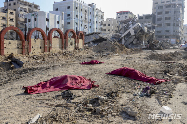 [가자시티=AP/뉴시스] 1월2일 가자지구 가자 시티 주요 도로에 이스라엘의 폭격으로 숨진 팔레스타인 주민들의 시신이 담요에 덮여 있다.  2024.01.03.