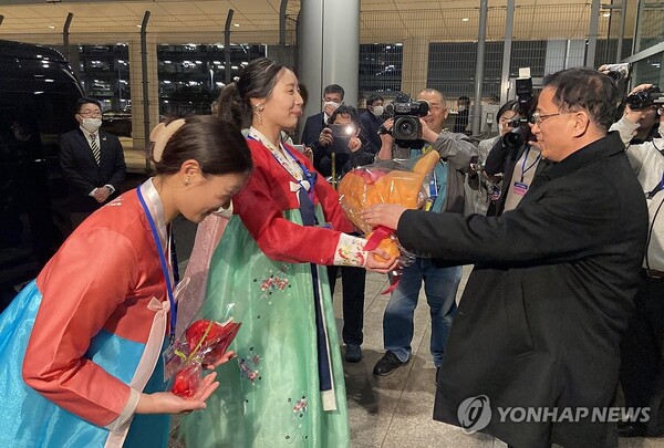한복을 입은 재일본조선인총연합회(조총련) 여성들이 25일 도쿄 하네다공항에 도착한 북한 여자축구 대표팀 관계자에게 꽃다발을 전달하고 있다. (출처: 연합뉴스)