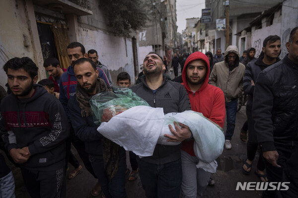 지난달 17일(현지시간) 가자지구 남부 라파에서 이스라엘의 공습으로 사망한 딸 마사의 장례식을 치르는 모하마드 쇼만이 딸의 시신을 옮기고 있다. (출처: 뉴시스)