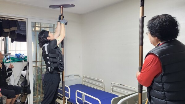 사진은 한 요양보호사가 어르신 가정에 방문해 안전바를 설치하고 있는 모습. (제공 청주 러브러브홈케어 요양원)