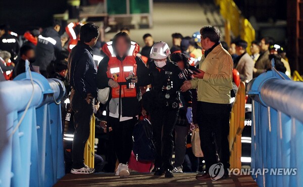 19일 오후 전남 목포시 목포해양경찰서 전용 부두로 여객선 퀸제누비아2호 탑승객들이 구조돼 이동하고 있다. 267명이 탑승한 퀸제누비아2호는 이날 오후 8시 17분께 전남 신안군 장산도 남방 족도에 좌초됐다. (출처: 연합뉴스)